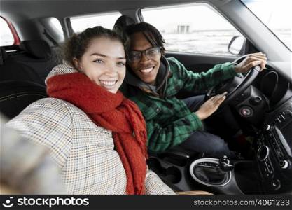 young couple traveling with car
