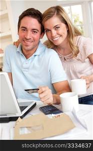 Young couple using credit card on the internet