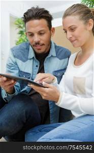 young couple using digital tablet