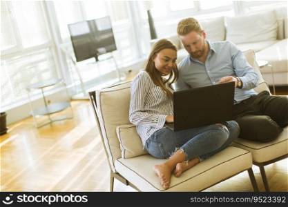 Young couple using laptop in the room