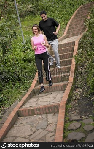 Young couple walking down steps
