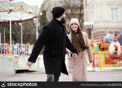 young couple walking holding hands