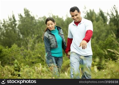 Young couple walking in a field