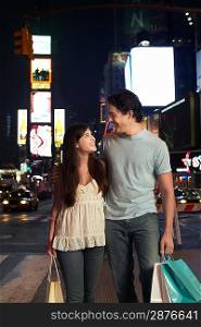 Young Couple Walking on City Street At Nighttimes