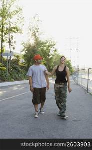 Young couple walking on the road and smiling