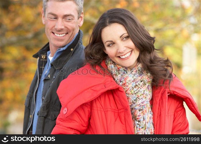 Young Couple Walking Through Autumn Park