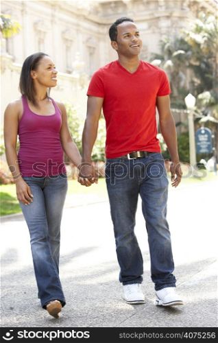 Young Couple Walking Through City Street