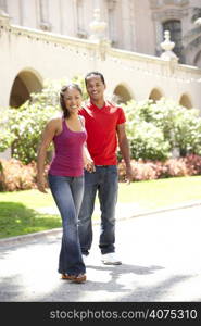 Young Couple Walking Through City Street