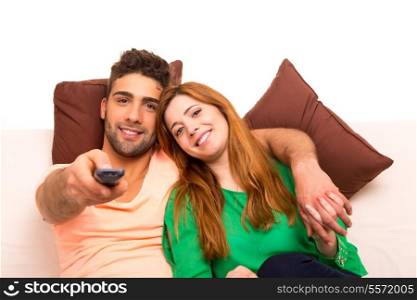 Young couple watching something on the television in the couch
