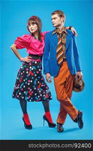 Young couple wearing colorful old-fashion clothes in pinup style. Also they can represent members of a youth counterculture Stilyagi existed from the late 1940s until the early 1960s in the Soviet Union