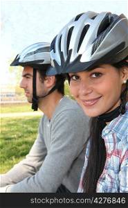 Young couple wearing cycle helmets