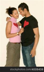 Young couple wearing heart shapes