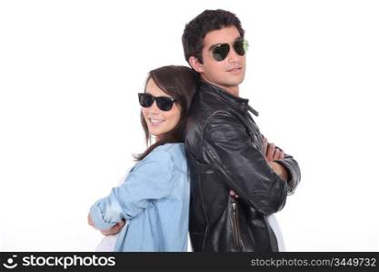 Young couple wearing sunglasses and trendy clothing