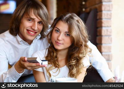 Young couple with a ring during an engagement in a restaurant