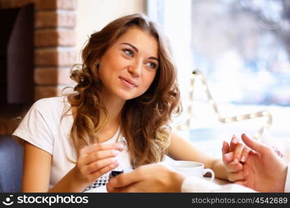 Young couple with a ring during an engagement in a restaurant