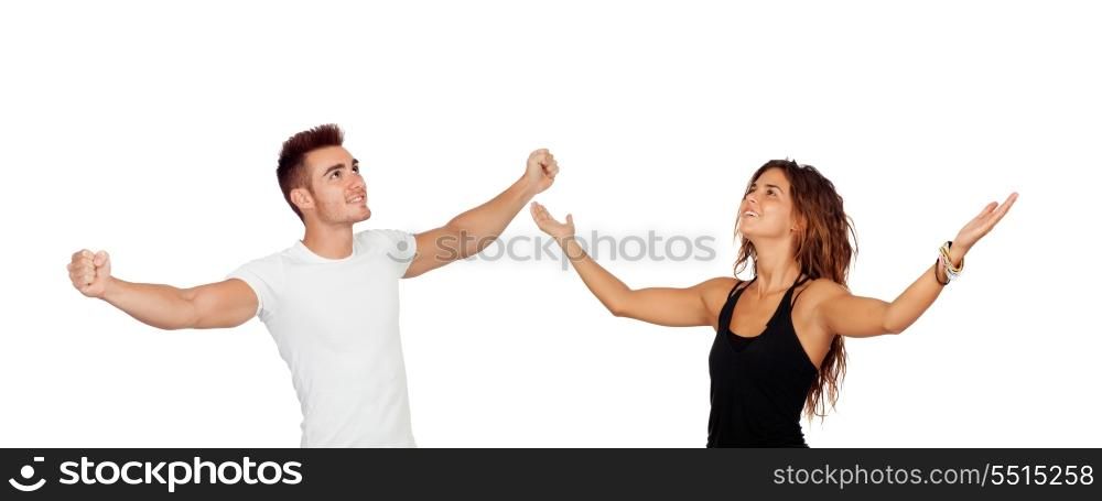 Young couple with arms raised celebrating something isolated on a white background
