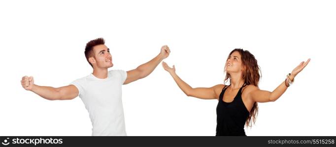Young couple with arms raised celebrating something isolated on a white background