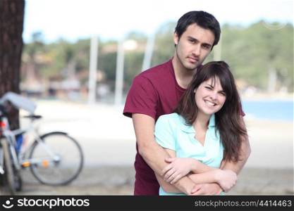 Young couple with bikes by a lake