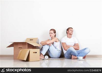 Young Couple with boxes and broken cup