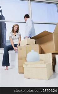 Young couple with cardboard boxes in a room