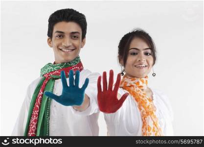 Young couple with coloured palms