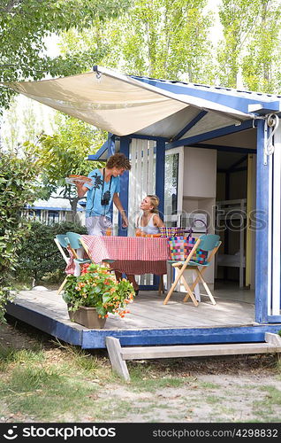 Young couple with desert on terrace cabin