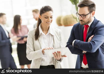 Young couple with digital tablet in the modern office