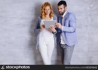 Young couple with digital tablet in the modern office