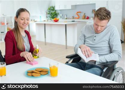 young couple with disabled boyfriend having breakfast together