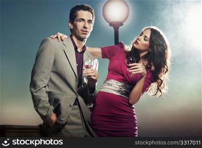 Young couple with glasses of wine