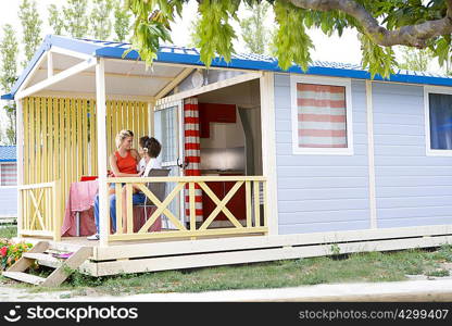 Young couple with headphones on terrace