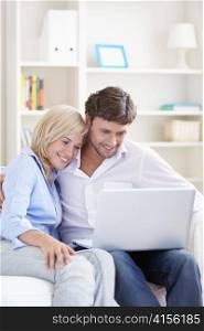 Young couple with laptop at home