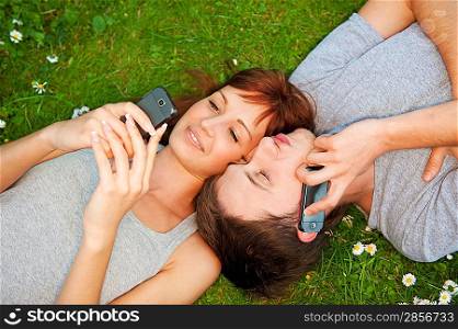 Young couple with mobile phones outdoor
