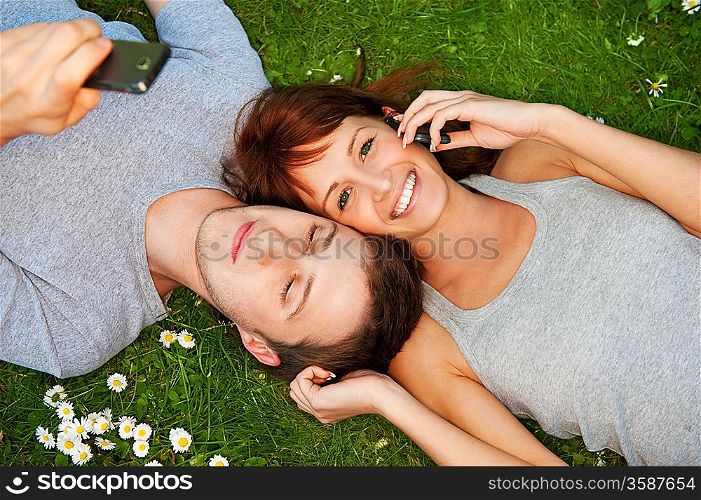Young couple with mobile phones outdoor