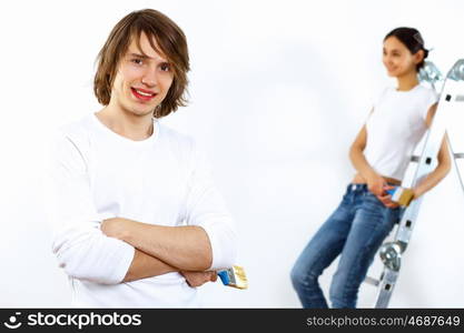 Young couple with paint brushes doing renovation together