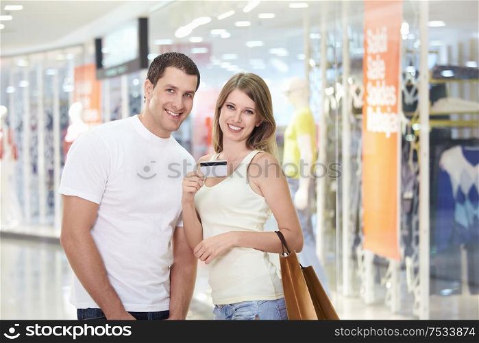 Young couple with purchases in the store
