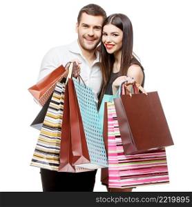 Young Couple with shopping bags isolated on white. Couple with shopping bags