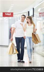 Young couple with shopping in store