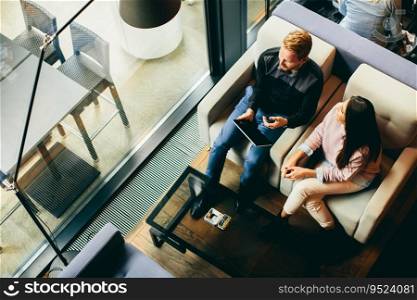 Young couple with tablet sitting in the cafe