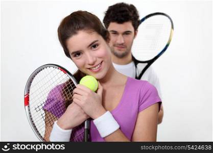 Young couple with tennis racquets