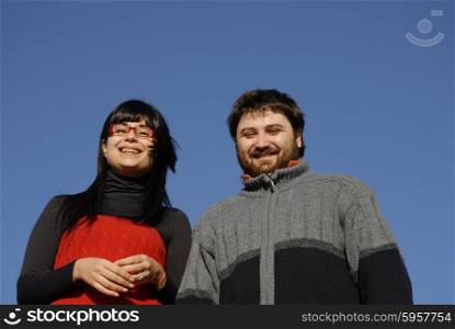 young couple with the sky as background
