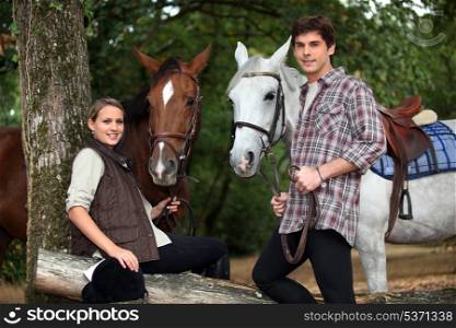 Young couple with two horses