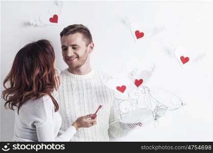 Young couple with winged hearts flying from the cage, Valentines day concept