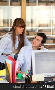 Young couple working at an office desk