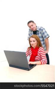 young couple working on laptop at office