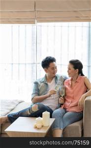 Young Couples celebrate together with wine in bedroom of contemporary house for modern lifestyle concept