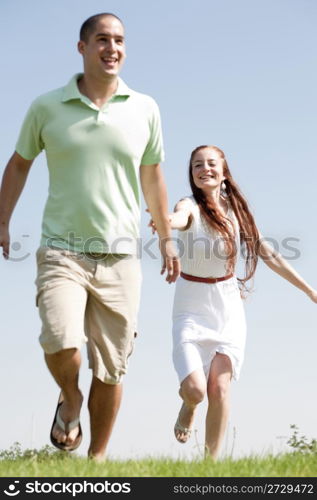 young Couples Running At Park, focus on the men