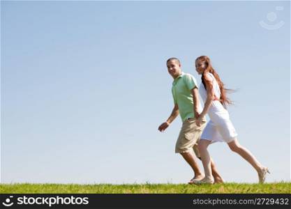 young Couples Running At Park Holding Hands and Smiling