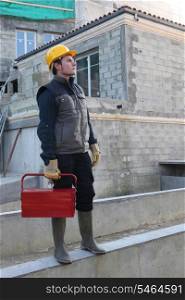 young craftsman outdoors in construction site