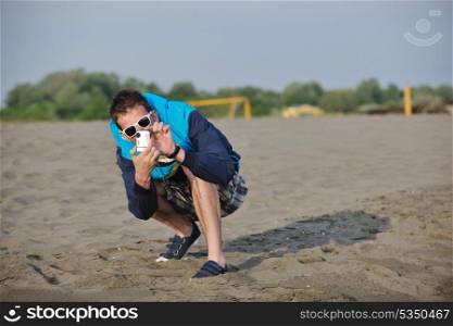 young creative amateur photographer taking snapshot photo with sunglasses on sunset